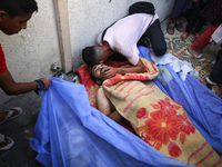 A mourner is reacting during the funeral of Palestinians killed in Israeli strikes, amid the Israel-Hamas conflict, in Deir Al-Balah, in cen...