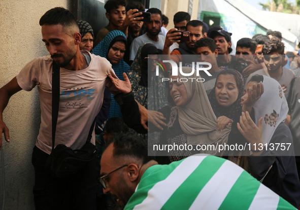 A mourner is reacting during the funeral of Palestinians killed in Israeli strikes, amid the Israel-Hamas conflict, in Deir Al-Balah, in cen...