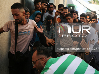 A mourner is reacting during the funeral of Palestinians killed in Israeli strikes, amid the Israel-Hamas conflict, in Deir Al-Balah, in cen...