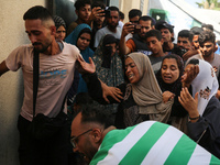 A mourner is reacting during the funeral of Palestinians killed in Israeli strikes, amid the Israel-Hamas conflict, in Deir Al-Balah, in cen...