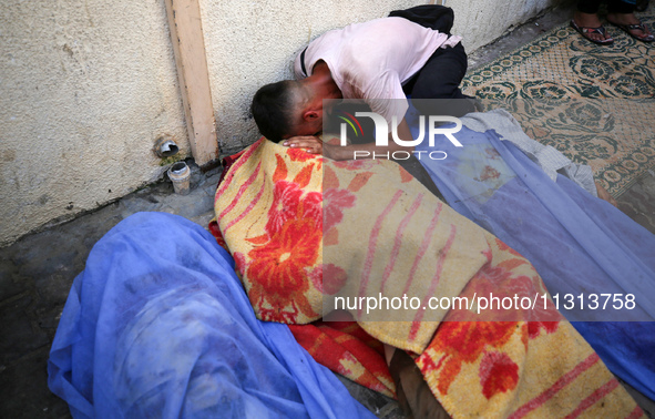 A mourner is reacting during the funeral of Palestinians killed in Israeli strikes, amid the Israel-Hamas conflict, in Deir Al-Balah, in cen...