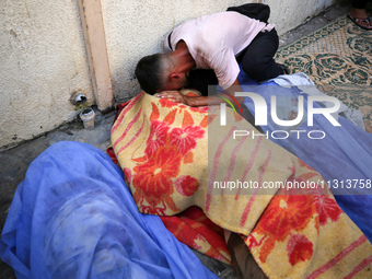 A mourner is reacting during the funeral of Palestinians killed in Israeli strikes, amid the Israel-Hamas conflict, in Deir Al-Balah, in cen...