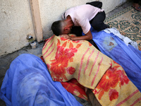 A mourner is reacting during the funeral of Palestinians killed in Israeli strikes, amid the Israel-Hamas conflict, in Deir Al-Balah, in cen...