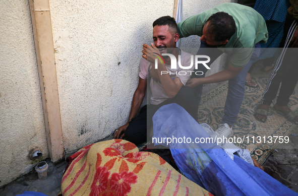 A mourner is reacting during the funeral of Palestinians killed in Israeli strikes, amid the Israel-Hamas conflict, in Deir Al-Balah, in cen...