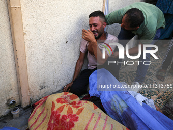 A mourner is reacting during the funeral of Palestinians killed in Israeli strikes, amid the Israel-Hamas conflict, in Deir Al-Balah, in cen...