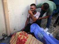 A mourner is reacting during the funeral of Palestinians killed in Israeli strikes, amid the Israel-Hamas conflict, in Deir Al-Balah, in cen...