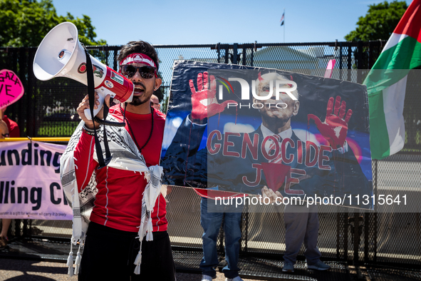 A protester holds a poster of 'Genocide Joe' as thousands of pro-Palestinian demonstrators encircle the White House, forming a ‘red line’ to...