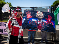 A protester holds a poster of 'Genocide Joe' as thousands of pro-Palestinian demonstrators encircle the White House, forming a ‘red line’ to...