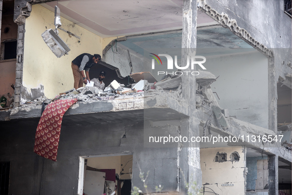 Palestinians are inspecting the damage and debris a day after an operation by the Israeli Special Forces in the Nuseirat camp, in the centra...