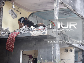 Palestinians are inspecting the damage and debris a day after an operation by the Israeli Special Forces in the Nuseirat camp, in the centra...