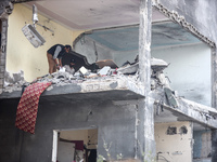 Palestinians are inspecting the damage and debris a day after an operation by the Israeli Special Forces in the Nuseirat camp, in the centra...