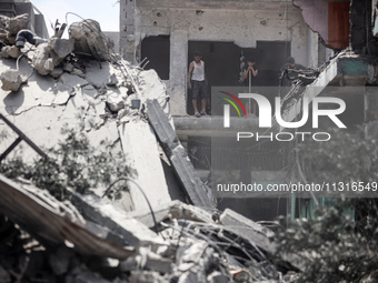 Palestinians are inspecting the damage and debris a day after an operation by the Israeli Special Forces in the Nuseirat camp, in the centra...