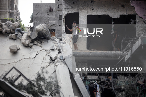 Palestinians are inspecting the damage and debris a day after an operation by the Israeli Special Forces in the Nuseirat camp, in the centra...