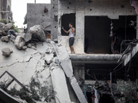 Palestinians are inspecting the damage and debris a day after an operation by the Israeli Special Forces in the Nuseirat camp, in the centra...