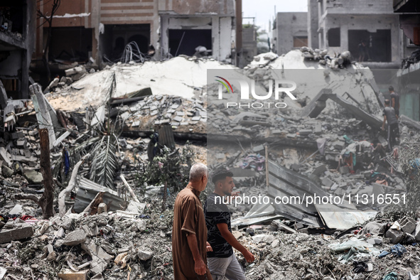 Palestinians are inspecting the damage and debris a day after an operation by the Israeli Special Forces in the Nuseirat camp, in the centra...