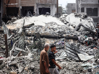 Palestinians are inspecting the damage and debris a day after an operation by the Israeli Special Forces in the Nuseirat camp, in the centra...