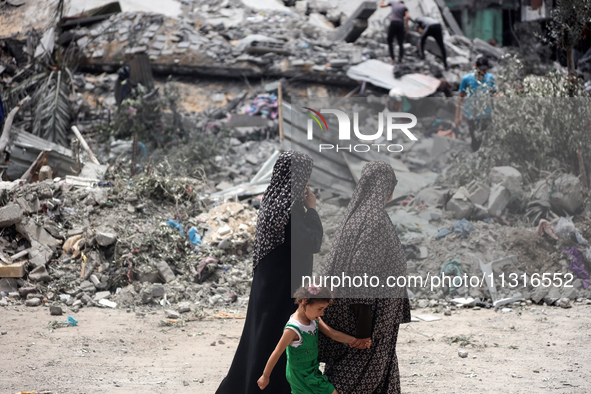 Palestinians are inspecting the damage and debris a day after an operation by the Israeli Special Forces in the Nuseirat camp, in the centra...