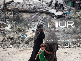 Palestinians are inspecting the damage and debris a day after an operation by the Israeli Special Forces in the Nuseirat camp, in the centra...