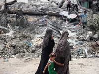 Palestinians are inspecting the damage and debris a day after an operation by the Israeli Special Forces in the Nuseirat camp, in the centra...