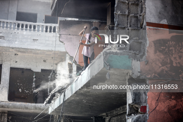 Palestinians are inspecting the damage and debris a day after an operation by the Israeli Special Forces in the Nuseirat camp, in the centra...