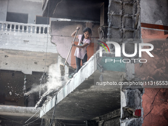 Palestinians are inspecting the damage and debris a day after an operation by the Israeli Special Forces in the Nuseirat camp, in the centra...