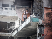 Palestinians are inspecting the damage and debris a day after an operation by the Israeli Special Forces in the Nuseirat camp, in the centra...