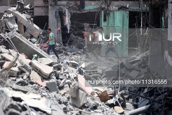 Palestinians are inspecting the damage and debris a day after an operation by the Israeli Special Forces in the Nuseirat camp, in the centra...