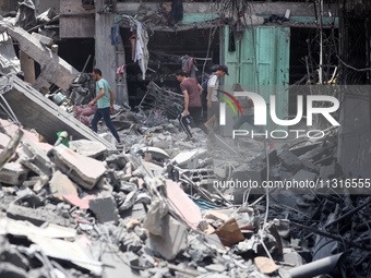 Palestinians are inspecting the damage and debris a day after an operation by the Israeli Special Forces in the Nuseirat camp, in the centra...