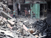 Palestinians are inspecting the damage and debris a day after an operation by the Israeli Special Forces in the Nuseirat camp, in the centra...