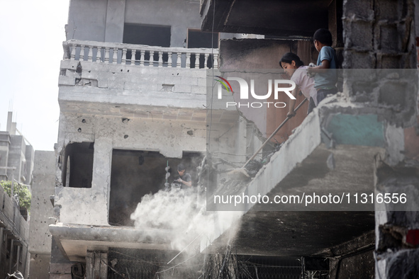 Palestinians are inspecting the damage and debris a day after an operation by the Israeli Special Forces in the Nuseirat camp, in the centra...