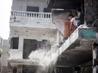 Palestinians are inspecting the damage and debris a day after an operation by the Israeli Special Forces in the Nuseirat camp, in the centra...