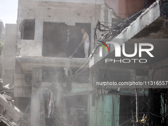 Palestinians are inspecting the damage and debris a day after an operation by the Israeli Special Forces in the Nuseirat camp, in the centra...