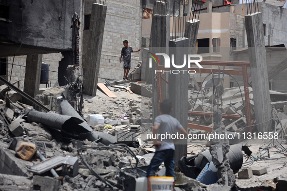 Palestinians are inspecting the damage and debris a day after an operation by the Israeli Special Forces in the Nuseirat camp, in the centra...