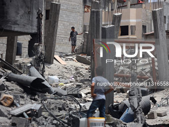 Palestinians are inspecting the damage and debris a day after an operation by the Israeli Special Forces in the Nuseirat camp, in the centra...