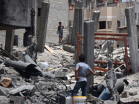 Palestinians are inspecting the damage and debris a day after an operation by the Israeli Special Forces in the Nuseirat camp, in the centra...