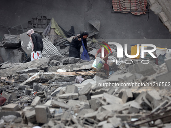 Palestinians are inspecting the damage and debris a day after an operation by the Israeli Special Forces in the Nuseirat camp, in the centra...