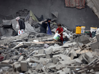 Palestinians are inspecting the damage and debris a day after an operation by the Israeli Special Forces in the Nuseirat camp, in the centra...