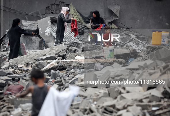 Palestinians are inspecting the damage and debris a day after an operation by the Israeli Special Forces in the Nuseirat camp, in the centra...