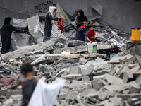 Palestinians are inspecting the damage and debris a day after an operation by the Israeli Special Forces in the Nuseirat camp, in the centra...