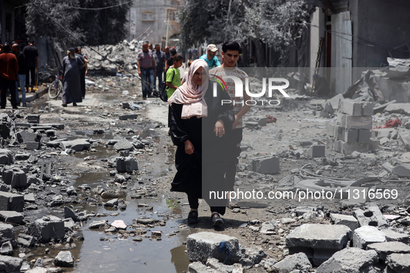 Palestinians are inspecting the damage and debris a day after an operation by the Israeli Special Forces in the Nuseirat camp, in the centra...