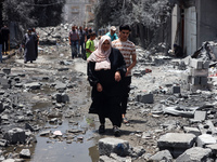 Palestinians are inspecting the damage and debris a day after an operation by the Israeli Special Forces in the Nuseirat camp, in the centra...