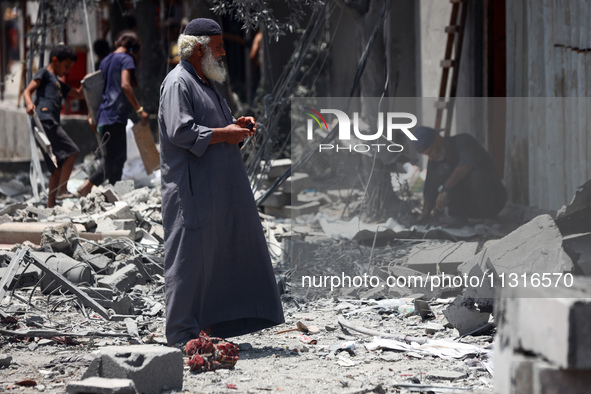 Palestinians are inspecting the damage and debris a day after an operation by the Israeli Special Forces in the Nuseirat camp, in the centra...