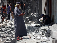 Palestinians are inspecting the damage and debris a day after an operation by the Israeli Special Forces in the Nuseirat camp, in the centra...