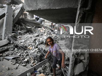 Palestinians are inspecting the damage and debris a day after an operation by the Israeli Special Forces in the Nuseirat camp, in the centra...