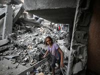 Palestinians are inspecting the damage and debris a day after an operation by the Israeli Special Forces in the Nuseirat camp, in the centra...