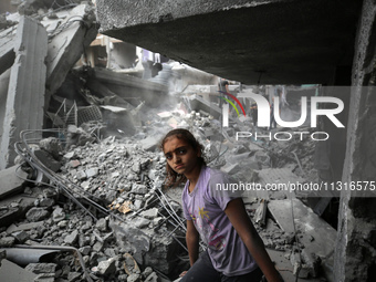 Palestinians are inspecting the damage and debris a day after an operation by the Israeli Special Forces in the Nuseirat camp, in the centra...