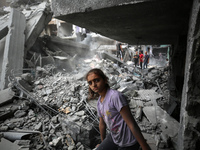 Palestinians are inspecting the damage and debris a day after an operation by the Israeli Special Forces in the Nuseirat camp, in the centra...