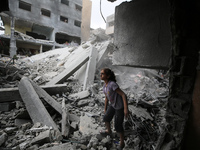 Palestinians are inspecting the damage and debris a day after an operation by the Israeli Special Forces in the Nuseirat camp, in the centra...