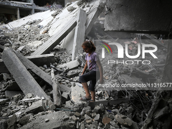 Palestinians are inspecting the damage and debris a day after an operation by the Israeli Special Forces in the Nuseirat camp, in the centra...