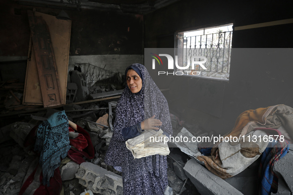 Palestinians are inspecting the damage and debris a day after an operation by the Israeli Special Forces in the Nuseirat camp, in the centra...